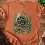 Orange t-shirt with a Halloween-themed D20 dice graphic surrounded by pumpkins and leaves.