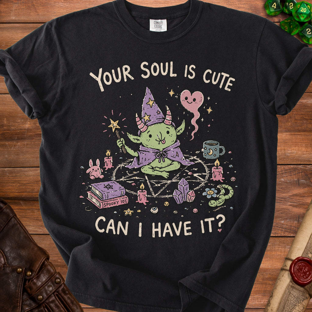 Black t-shirt with graphic of a cute goblin magician and text "Your soul is cute can I have it?".