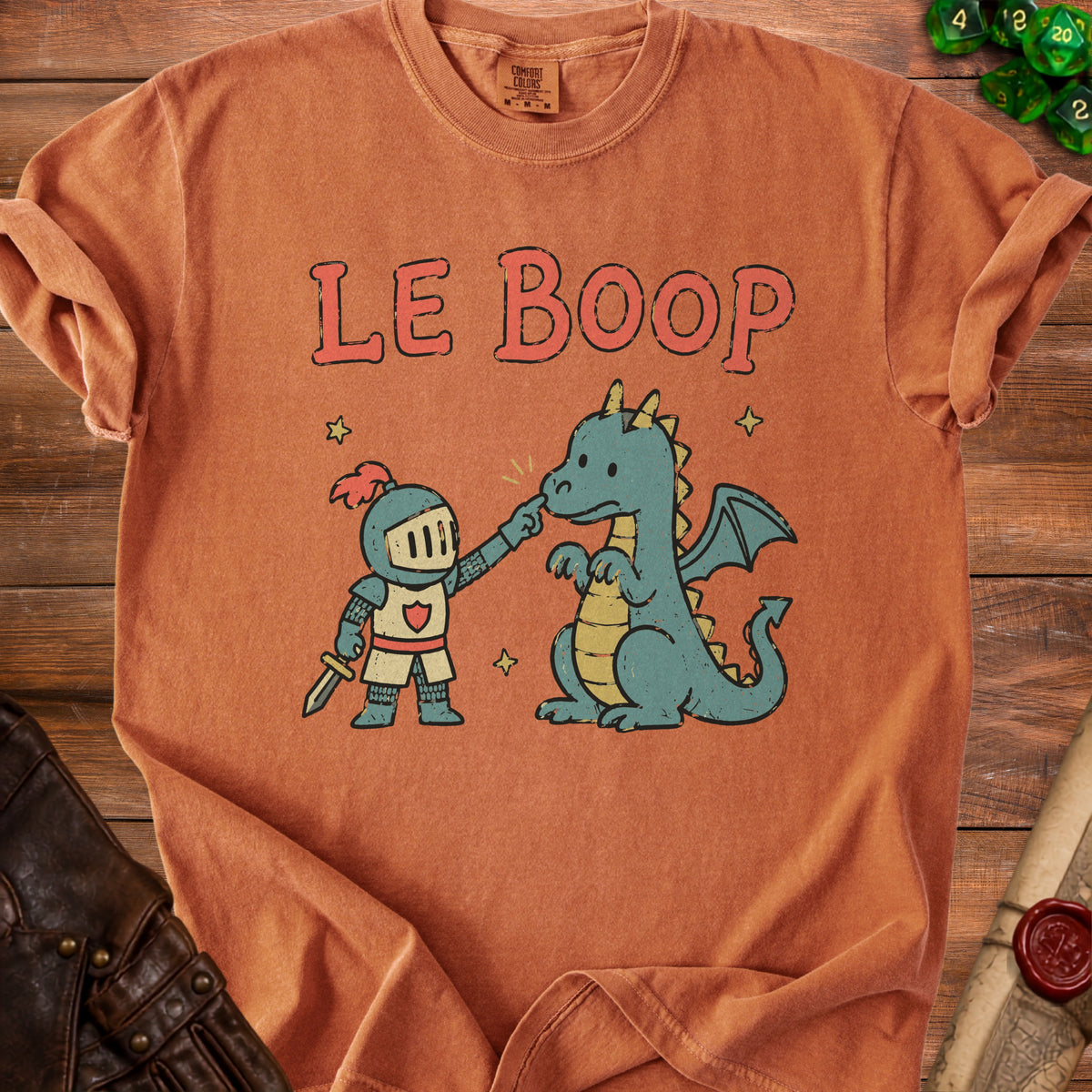Orange t-shirt graphic with text "LE BOOP" above a knight poking a dragon's nose.