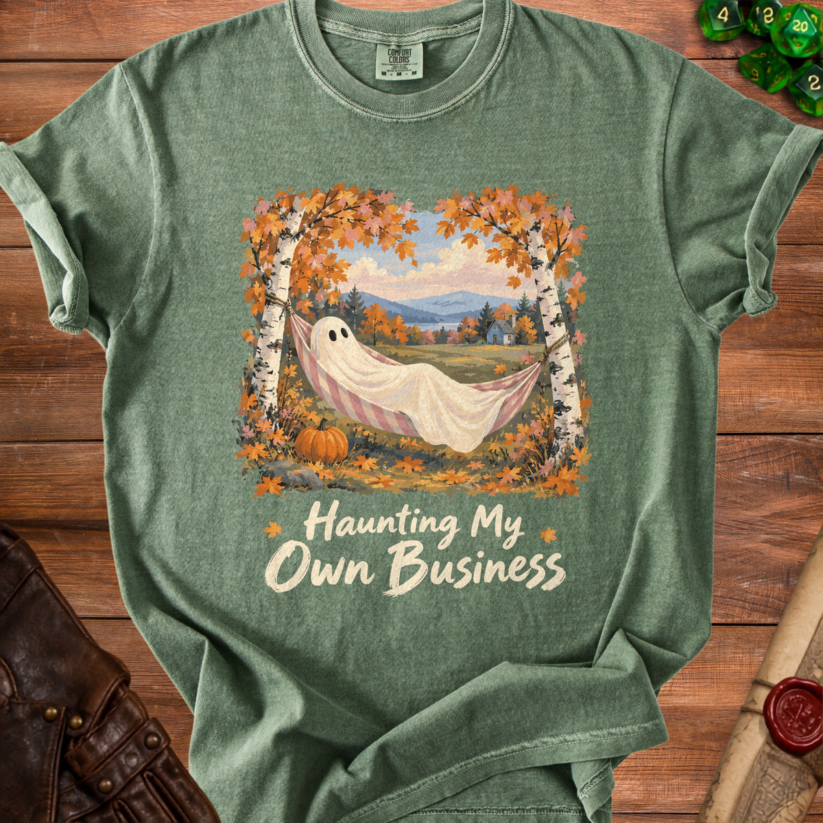 Ghost in hammock under autumn leaves, text "Haunting My Own Business".