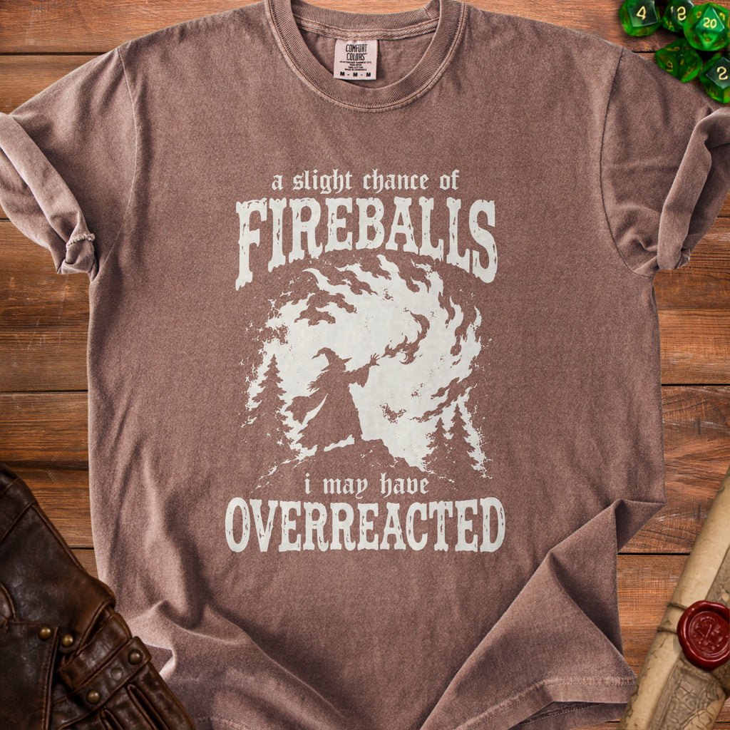 Brown t-shirt with white graphic: "a slight chance of FIREBALLS i may have OVERREACTED"