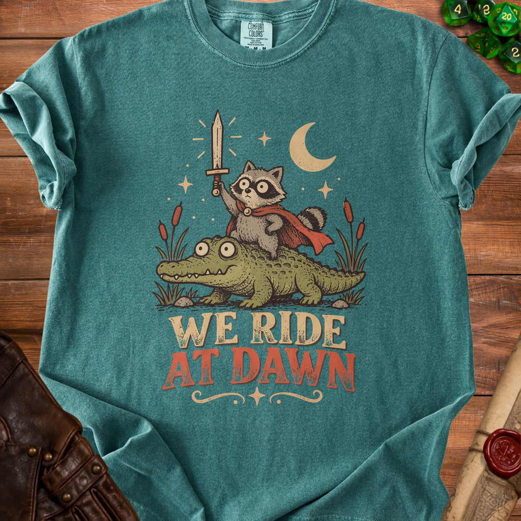Raccoon with sword riding an alligator with text "We Ride At Dawn."