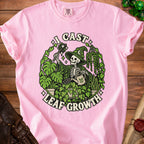 Pink t-shirt with skeleton wizard watering plants, text "I CAST LEAF GROWTH".