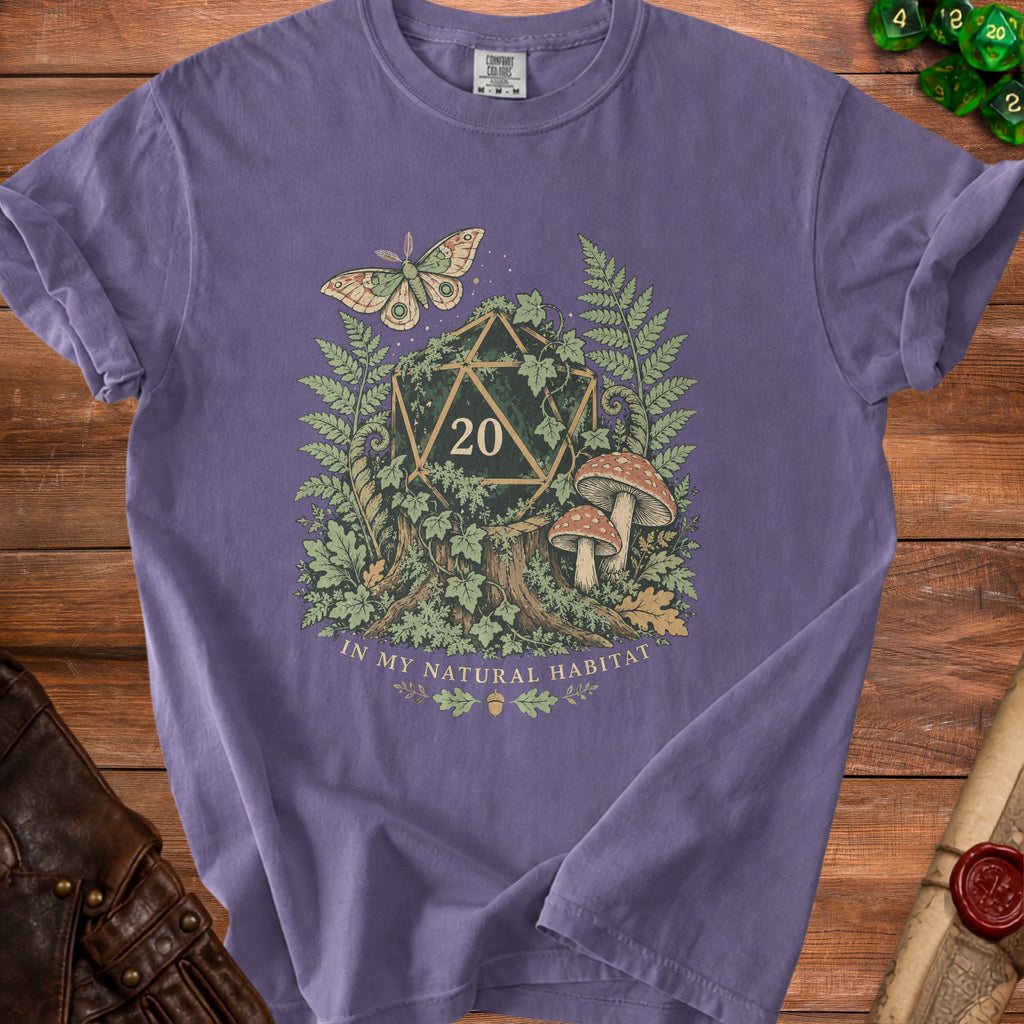 Purple t-shirt with a d20 die, moth, mushrooms, and text "IN MY NATURAL HABITAT".