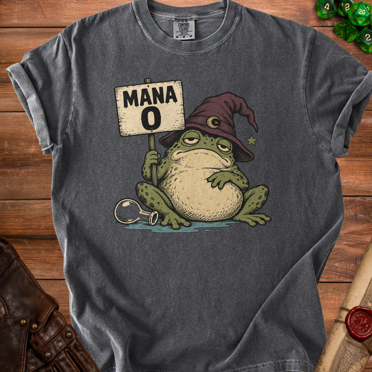 A charcoal grey t-shirt featuring a graphic of a sleepy frog wearing a wizard hat and holding a Mana 0 sign.