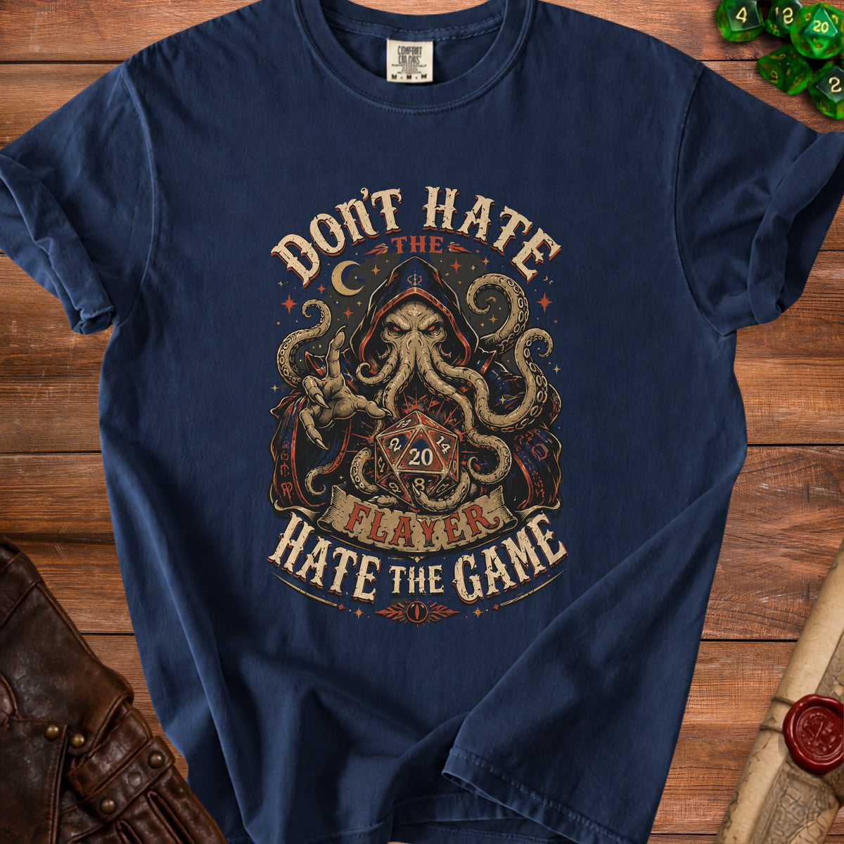 Dark blue t-shirt with a graphic of a hooded kraken and dice, reading "Don't Hate the Player, Hate the Game."