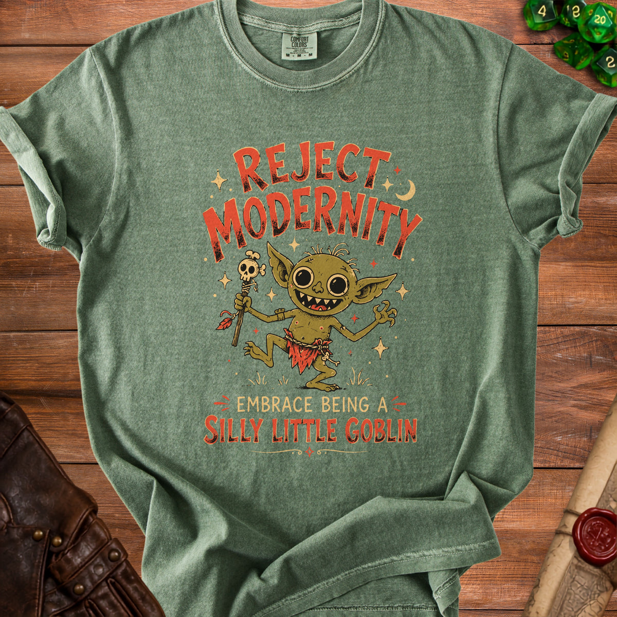Green t-shirt with "Reject Modernity Embrace Being a Silly Little Goblin" text and goblin graphic.