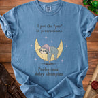 Blue t-shirt with sloth on moon graphic and text "I put the 'pro' in procrastinate".