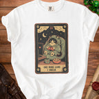 White t-shirt with tarot card graphic of a cat playing video games.