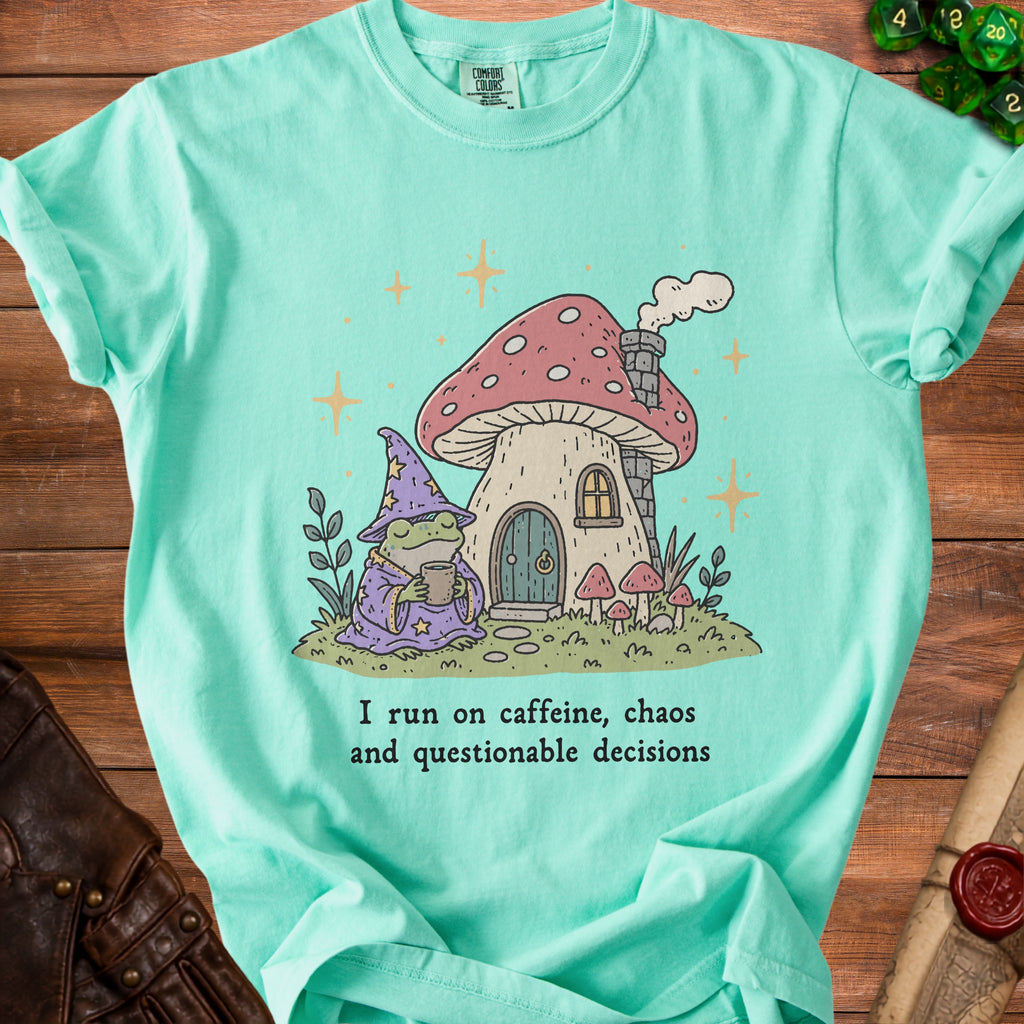 Mint t-shirt with frog wizard, mushroom house, and text "I run on caffeine, chaos and questionable decisions."