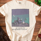 Cream t-shirt with a wizard by a campfire and text "NOT IGNORING YOU. JUST RECHARGING MY SOCIAL BATT".