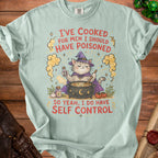 Light blue t-shirt with a witch cat stirring a cauldron and the text "I've cooked for men I should have poisoned, so yeah, I do have self control".