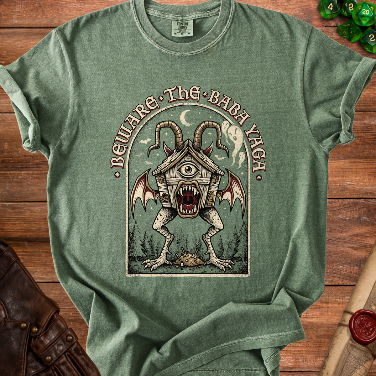 Green t-shirt with "Beware The Baba Yaga" text and a monster graphic.