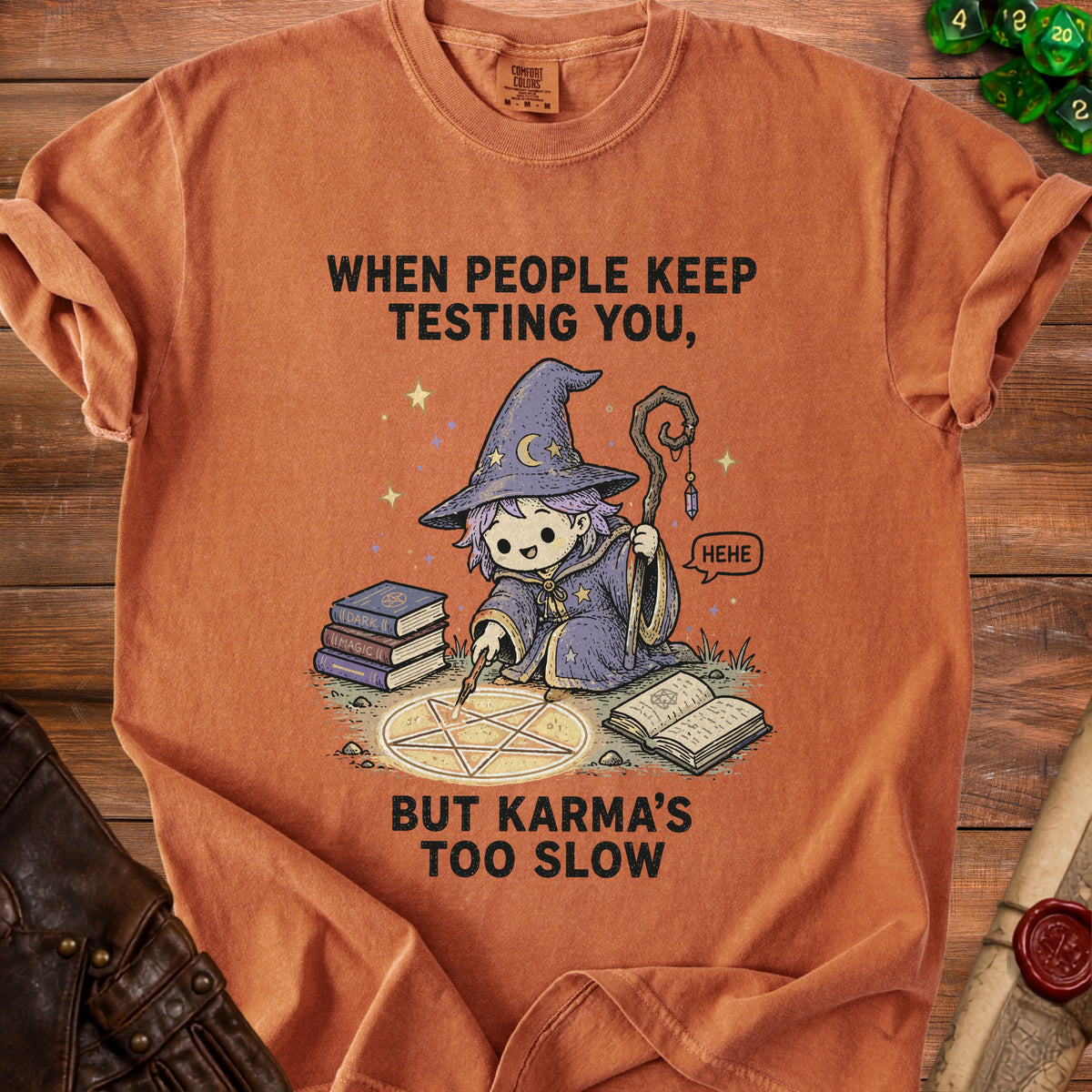 Orange t-shirt with a wizard and pentagram design reading "When people keep testing you, but karma's too slow."