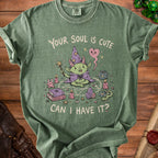 Green t-shirt with a cartoon goblin in a wizard hat and cape, saying "Your soul is cute, can I have it?".