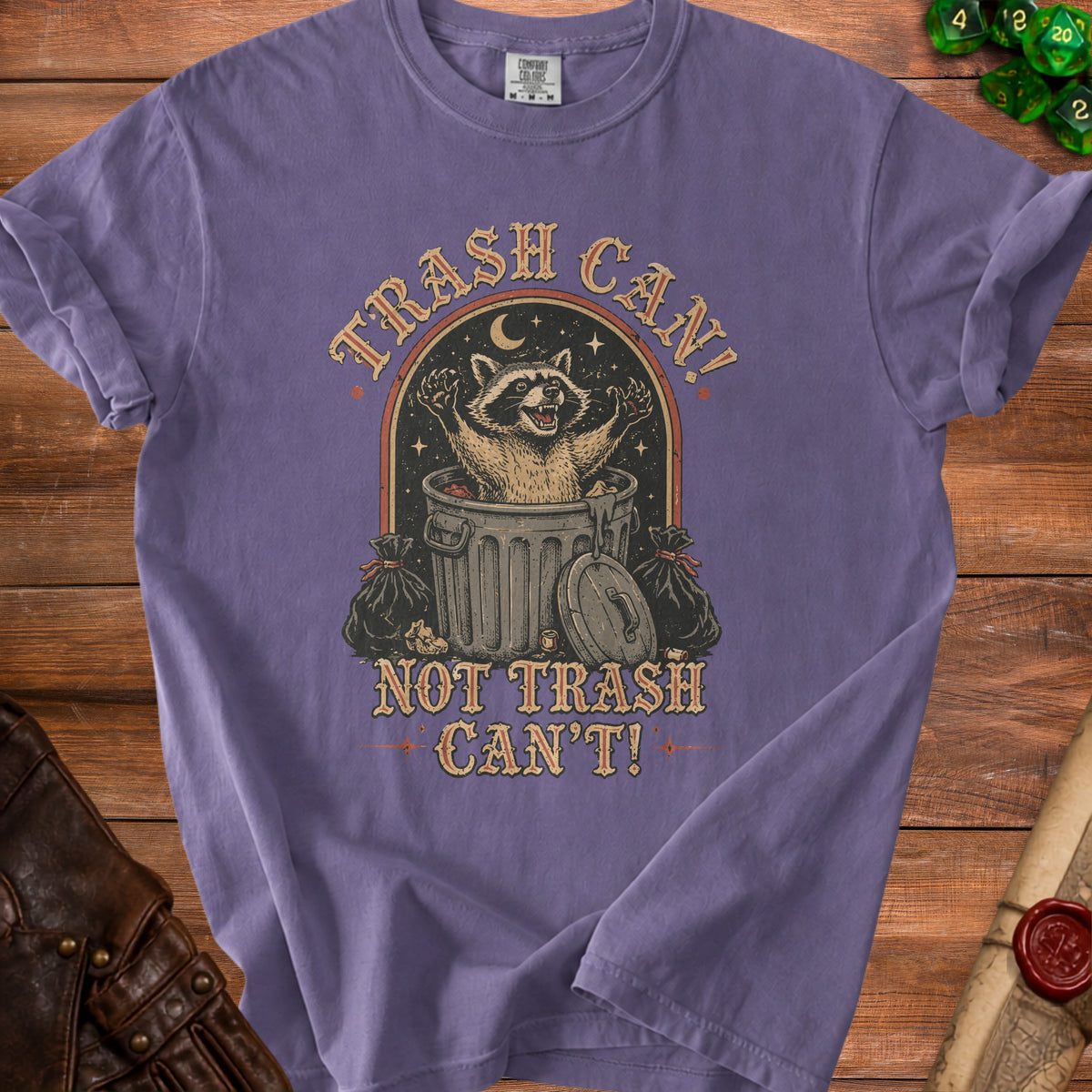 Purple t-shirt with graphic of raccoon in trash can saying "Trash Can! Not Trash Can't!"