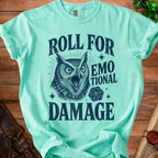 Aqua t-shirt with graphic of screaming owl, dice, and text "Roll for Emotional Damage".