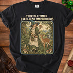 Black t-shirt with witch and deer in forest graphic, text "TERRIBLE TIMES EXCELLENT MUSHROOMS".