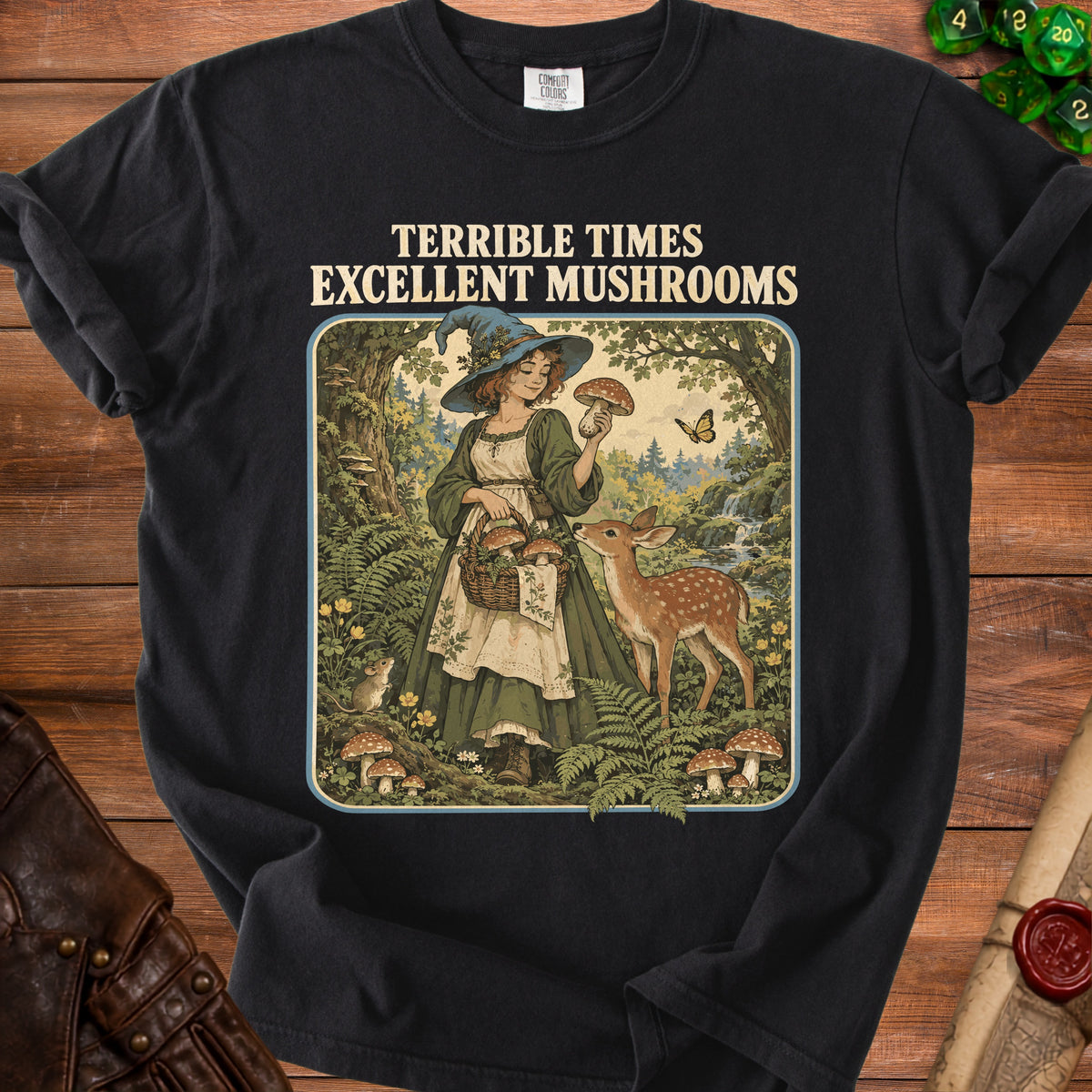Black t-shirt with witch and deer in forest graphic, text "TERRIBLE TIMES EXCELLENT MUSHROOMS".