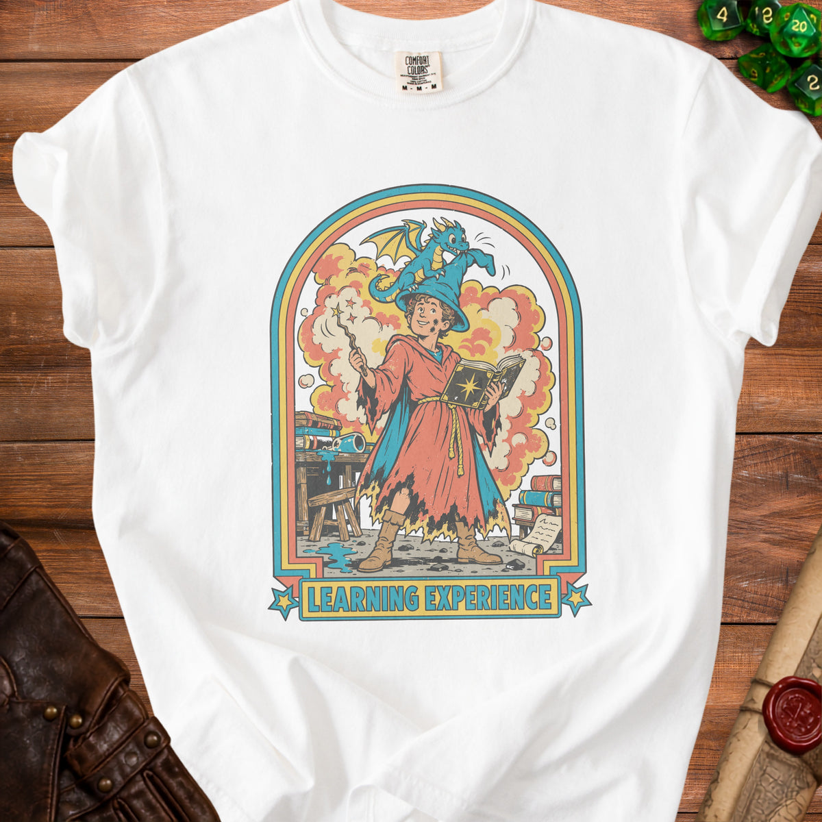 White t-shirt with a retro graphic of a wizard and dragon reading "Learning Experience".
