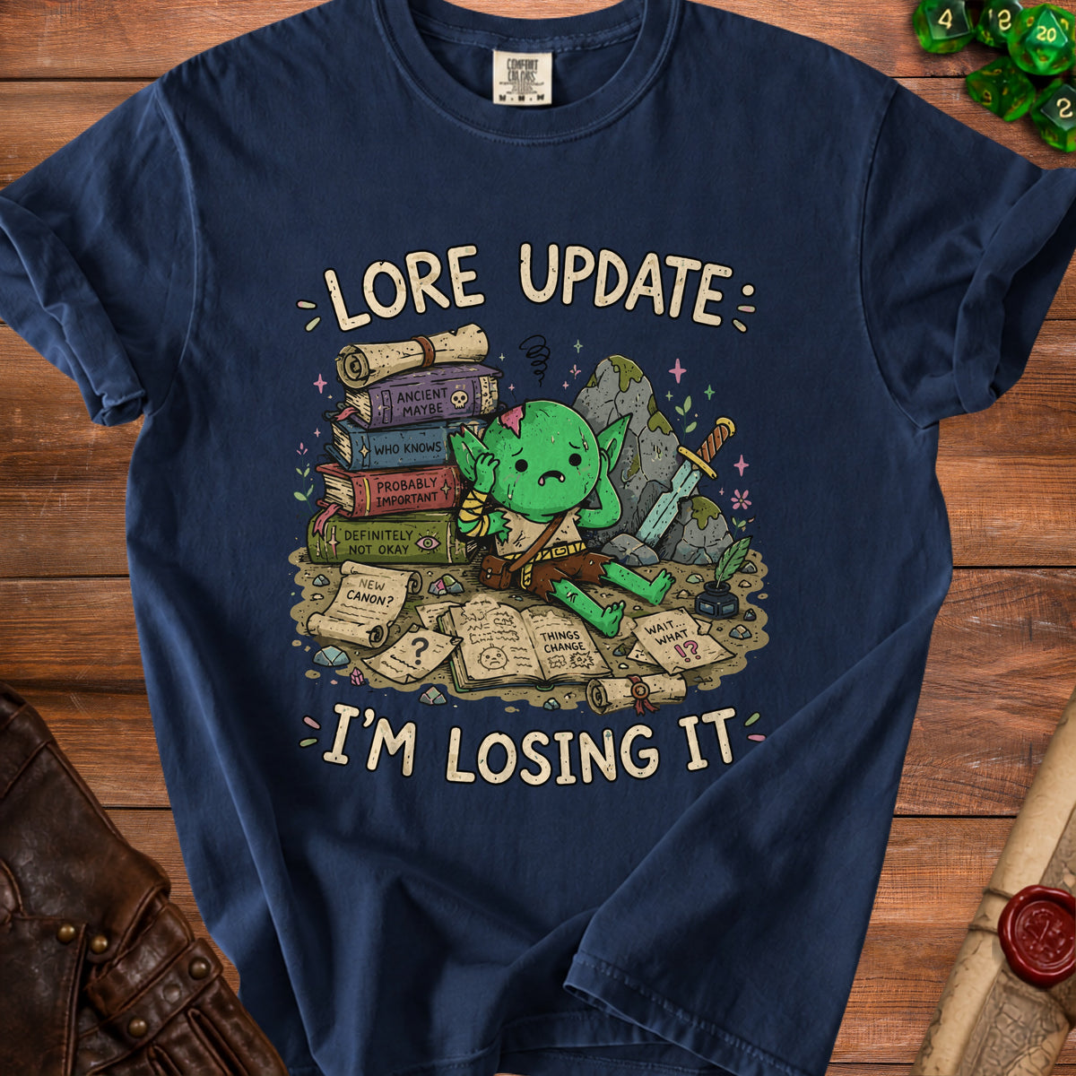 Navy t-shirt with a distressed graphic of a goblin and scrolls saying "Lore Update: I'm Losing It."