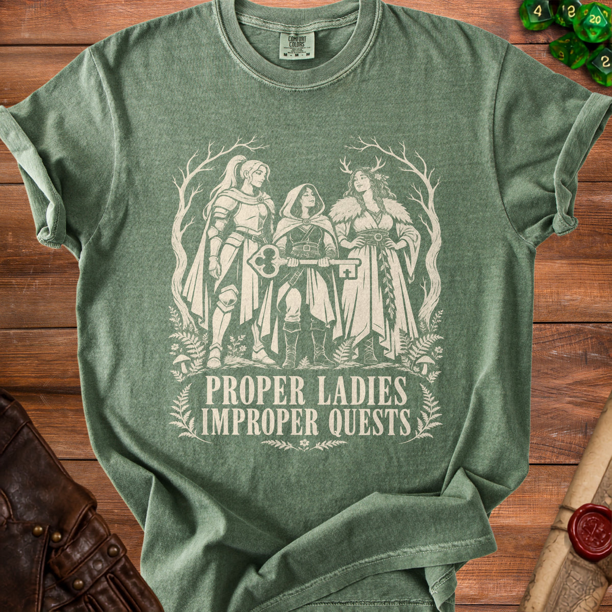 Green t-shirt with "Proper Ladies Improper Quests" and three women holding a key.