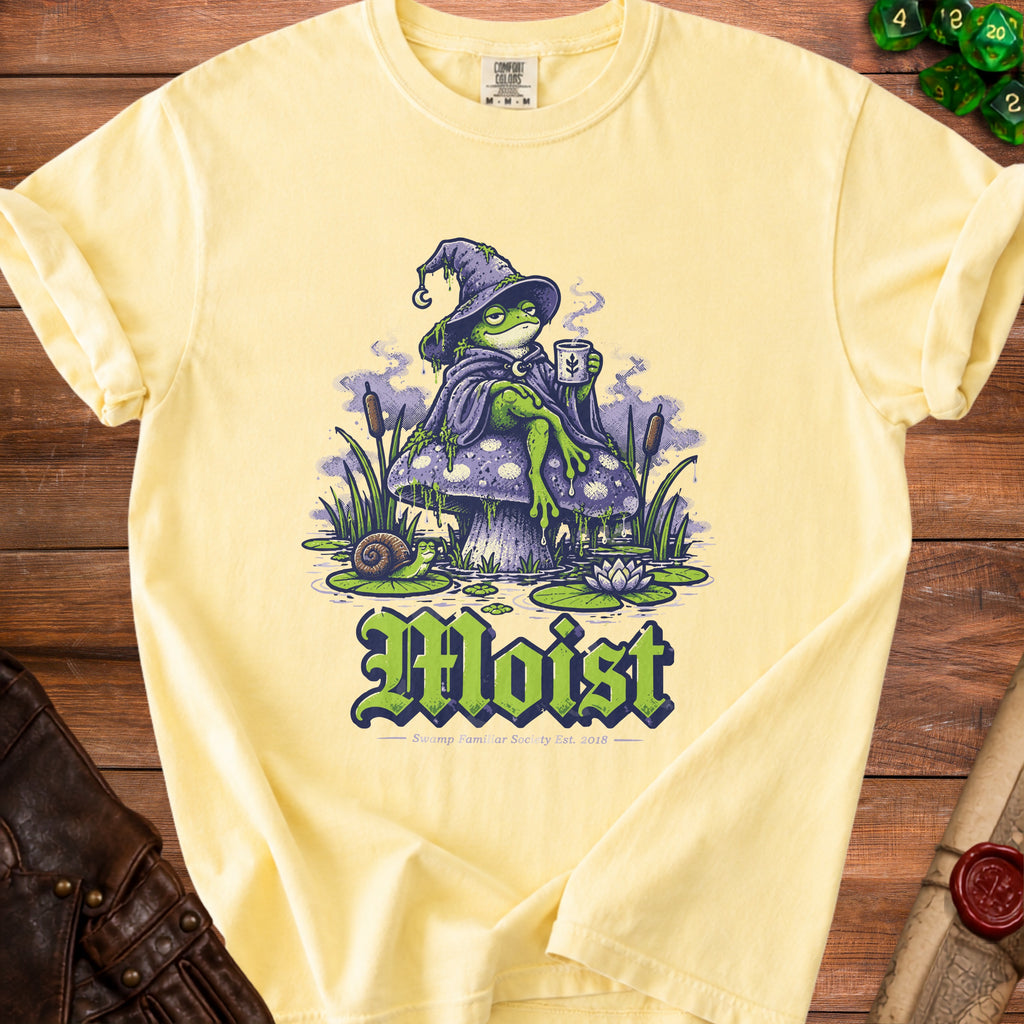 Yellow t-shirt with a wizard frog on a mushroom, text reads "Moist".