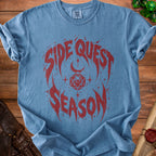 Blue t-shirt with red "Side Quest Season" graphic featuring dice and moon.
