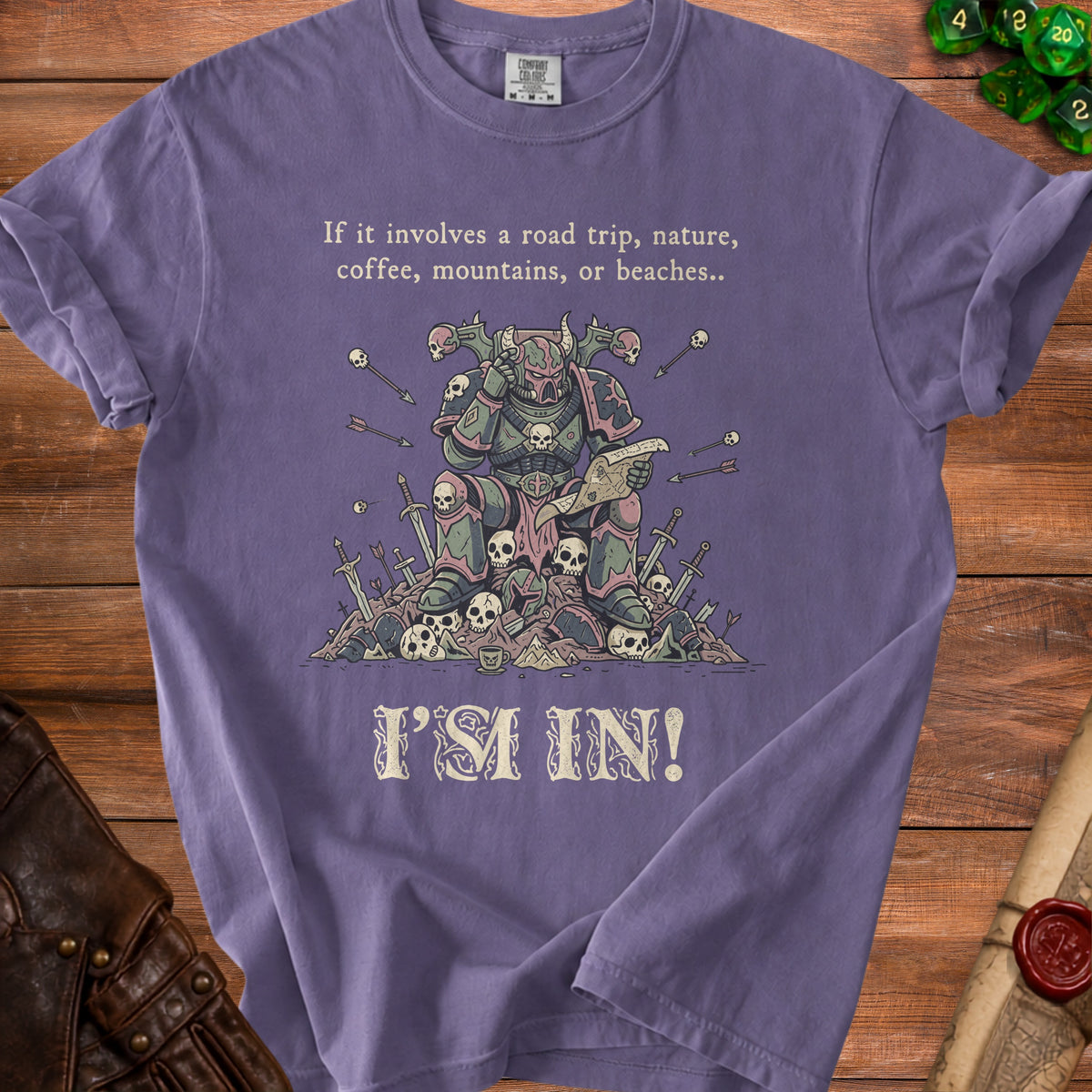 Purple t-shirt with illustration of warrior reading map, surrounded by skulls and swords, with text.