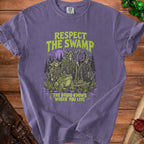 Purple t-shirt with "Respect the Swamp" and "The Druid Knows Where You Live" text and fantasy characters.
