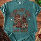 Devil sitting on skull throne with flames and text "It's Hell Out There Stay Inside".