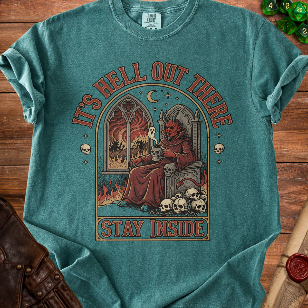 Devil sitting on skull throne with flames and text "It's Hell Out There Stay Inside".