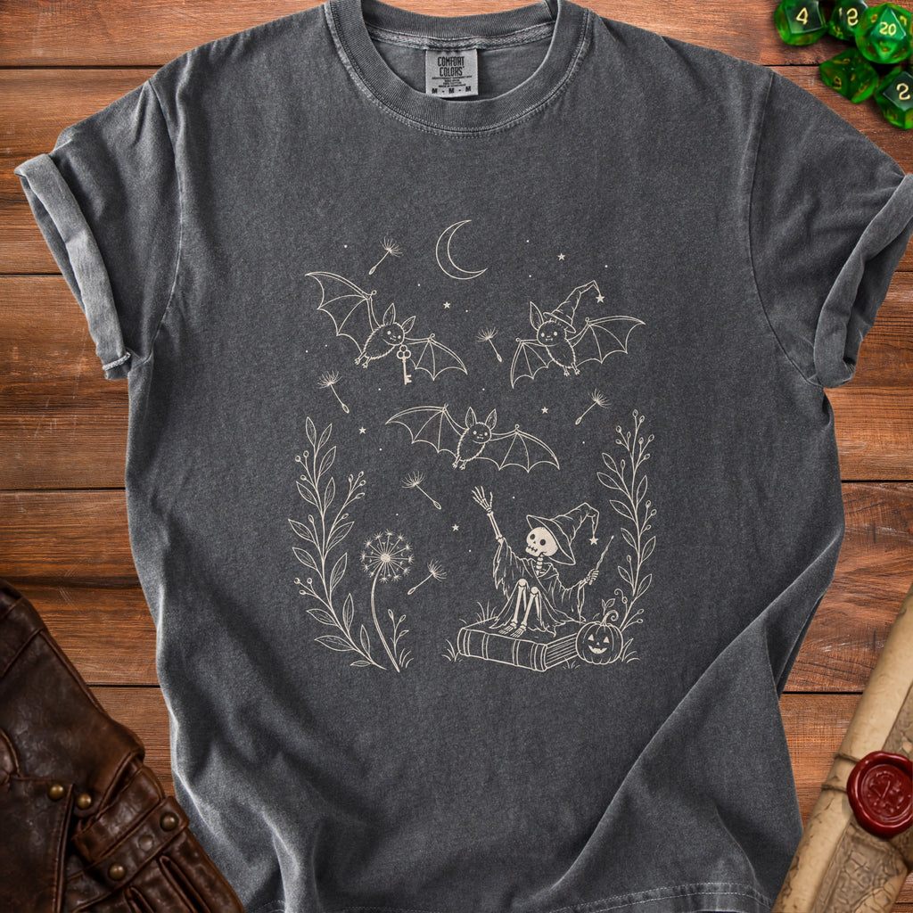 Dark grey t-shirt with a cream outline graphic of bats, a skeleton witch, and dandelions.
