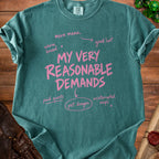 Teal t-shirt with pink text: "MY VERY REASONABLE DEMANDS" with related demands.