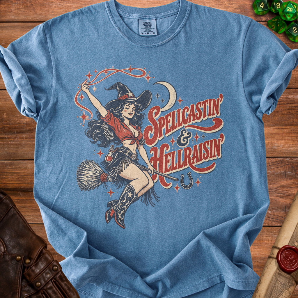 Blue t-shirt with a witch illustration and text "Spellcastin' & Hellraisin'".