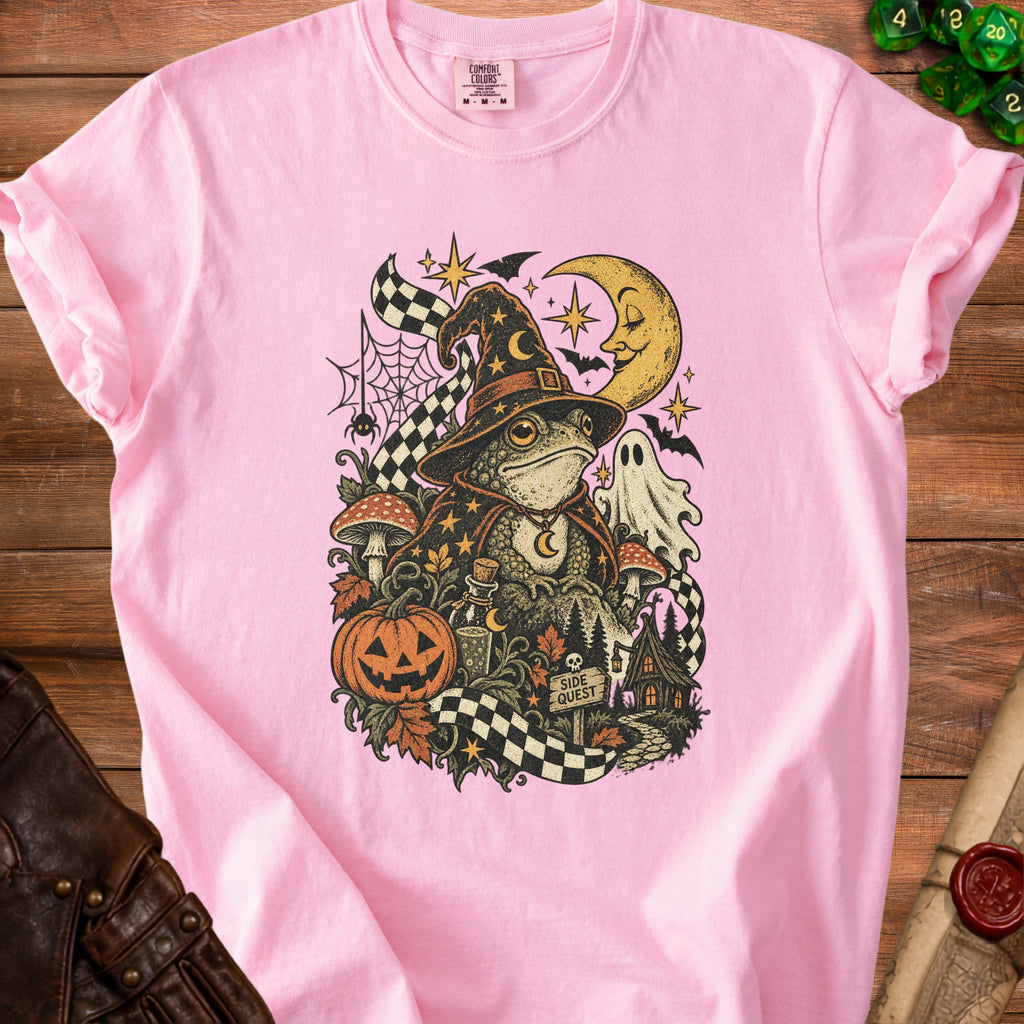 Pink t-shirt with a wizard frog and Halloween-themed graphic featuring a pumpkin and ghost.