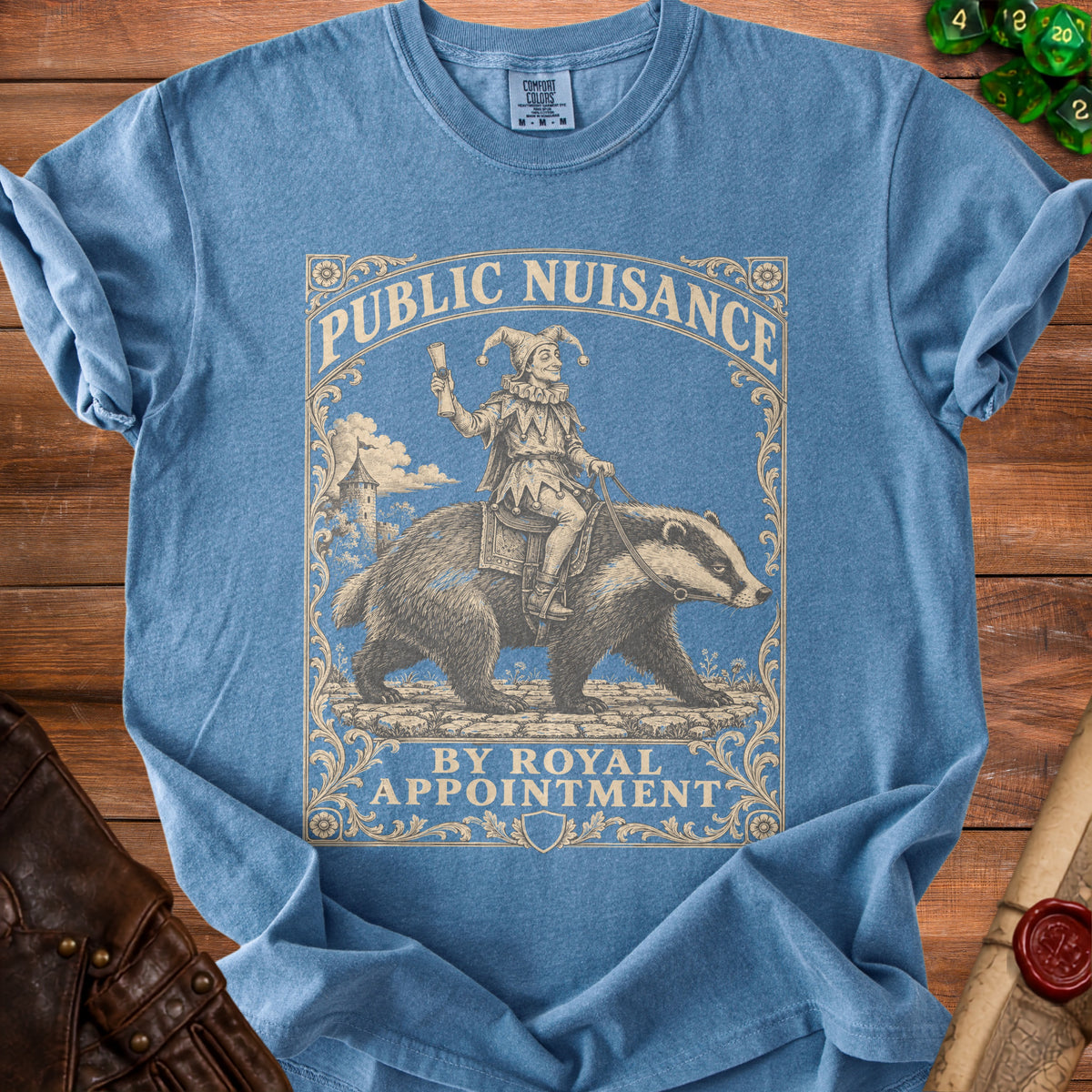 Blue t-shirt with "Public Nuisance By Royal Appointment" text and jester riding badger graphic.
