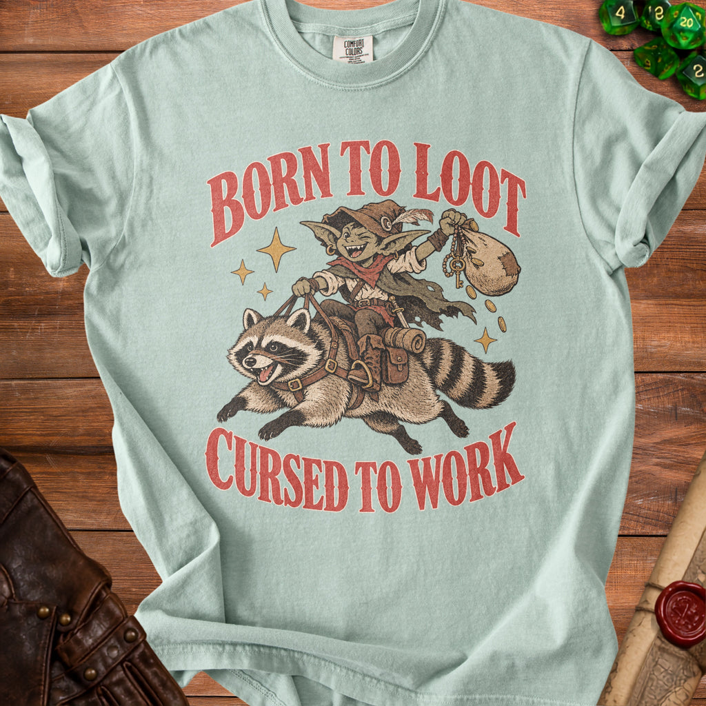 Light blue t-shirt with "Born to Loot Cursed to Work" text and goblin riding raccoon graphic.