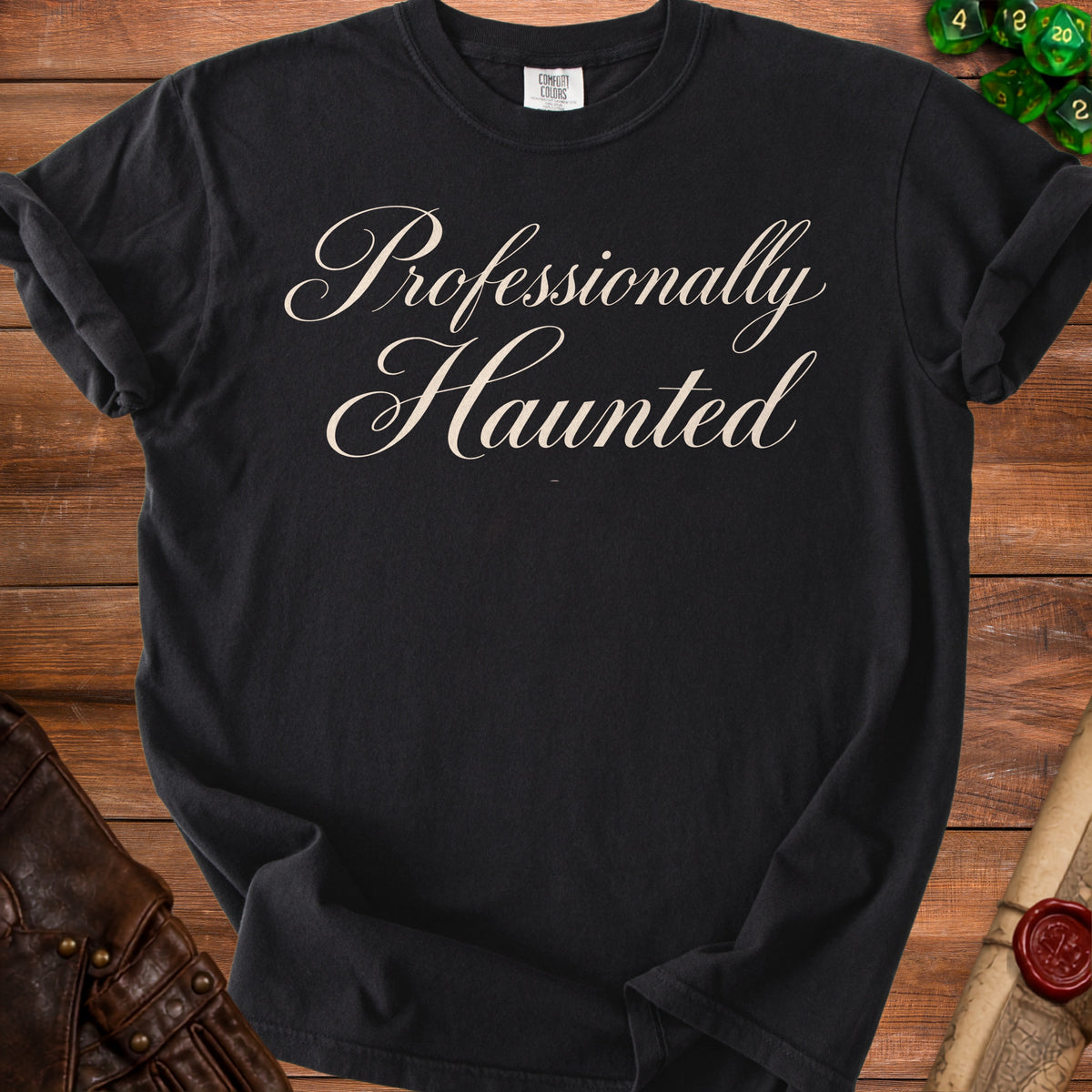 Black t-shirt with "Professionally Haunted" text in creamy script font.
