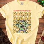 Yellow t-shirt with "EVERYDAY MY HEAD GOES" and a distressed cartoon monster.