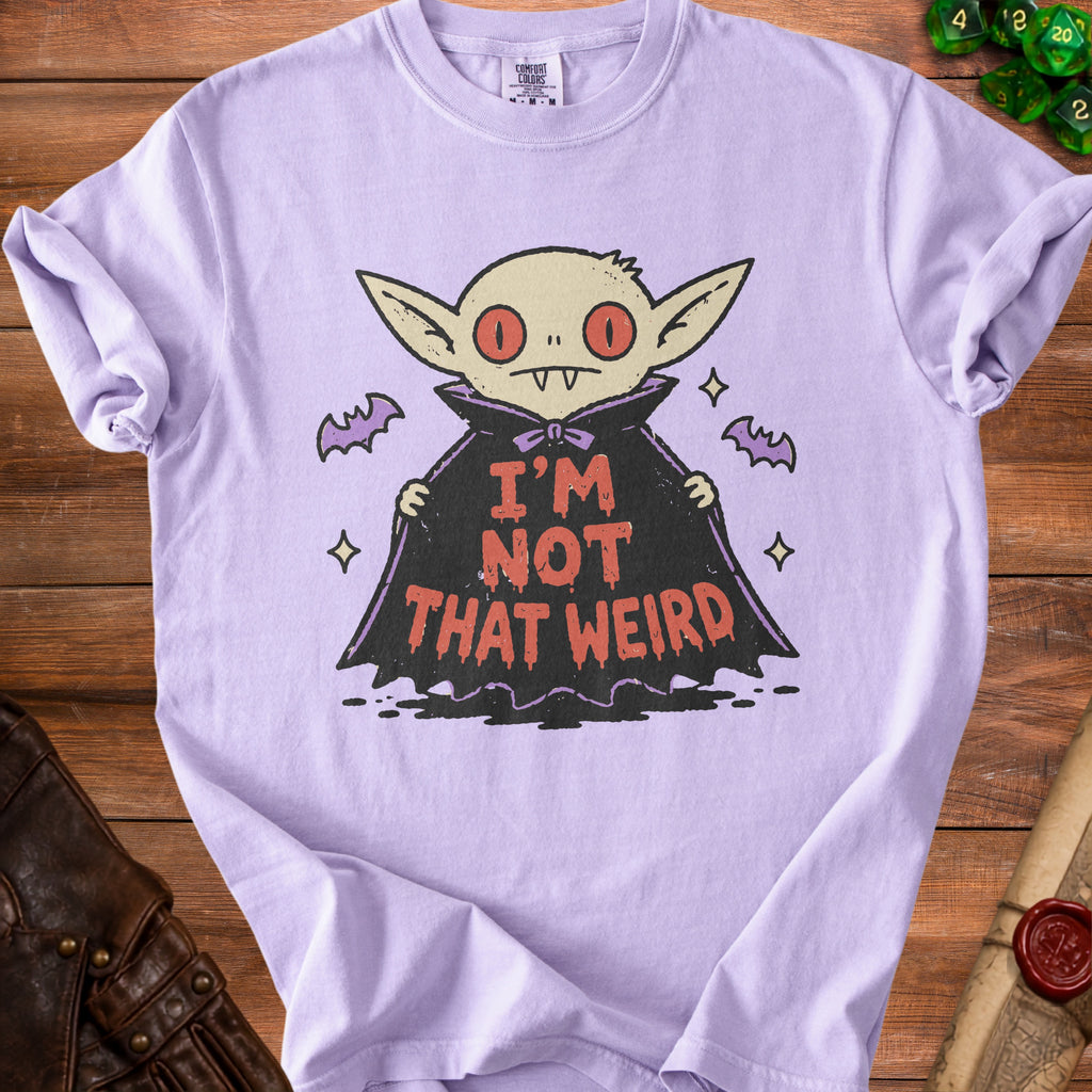 Purple t-shirt with a cartoon vampire graphic that says "I'M NOT THAT WEIRD".