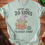 Light blue t-shirt with a frog in a wizard hat reading a book, next to a 20-sided die. Text reads "THERE ARE 20 SIDES TO EVERY STORY".