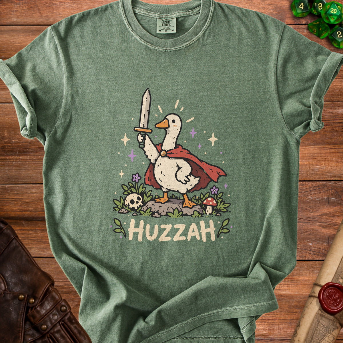 Green t-shirt featuring a cartoon duck in a cape holding a sword, with "HUZZAH" text.