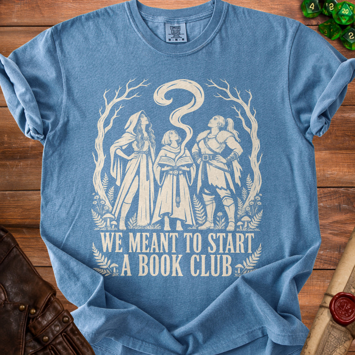 Blue t-shirt with graphic of three figures and text "WE MEANT TO START A BOOK CLUB".