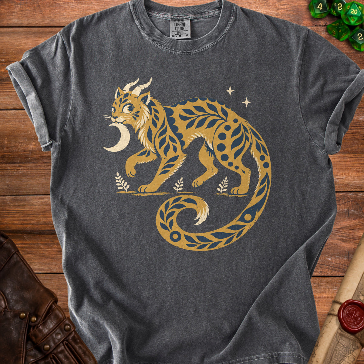 Dark gray t-shirt with a stylized golden cat creature, moon, and stars graphic.