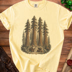 Yellow t-shirt with wizard, goblin, treasure chest, and sequoia trees graphic.