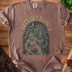Brown t-shirt with knight fighting medusa artwork and "LET'S GET STONED" text.