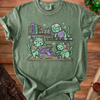 Three cats in armor raid a treasure chest with dice and fantasy books.