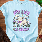 Light blue t-shirt with a cartoon lamb and the text "My Life Is Crap".