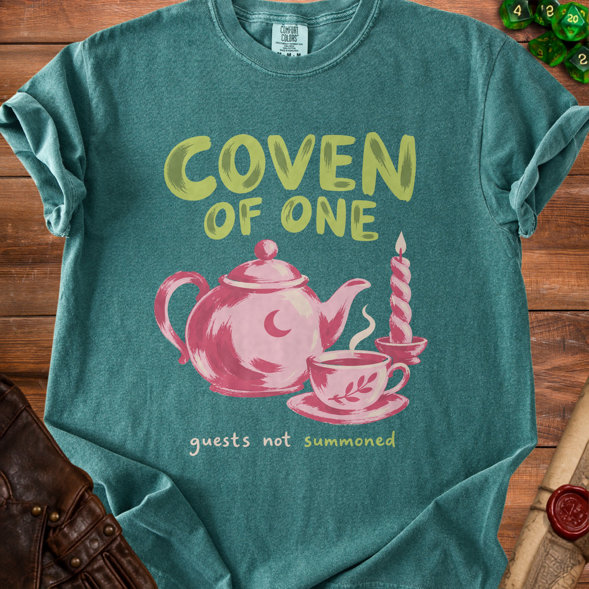 Teal t-shirt with "COVEN OF ONE" and "guests not summoned" text.